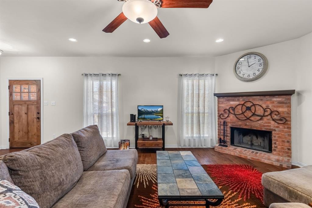 1308 Madeline Street Commerce, TX 75428 - Photo 6 of 37 a living room with furniture and a fireplace