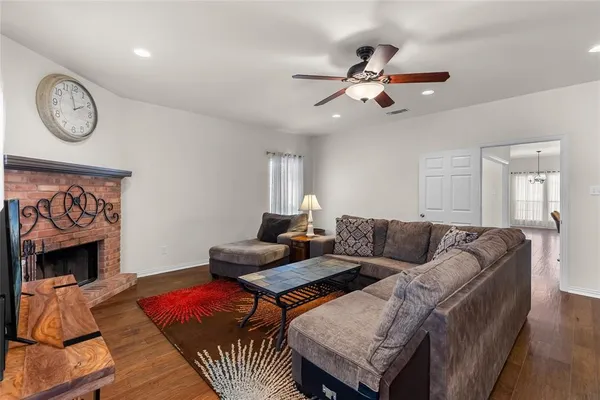 a living room with furniture a clock and a fireplace