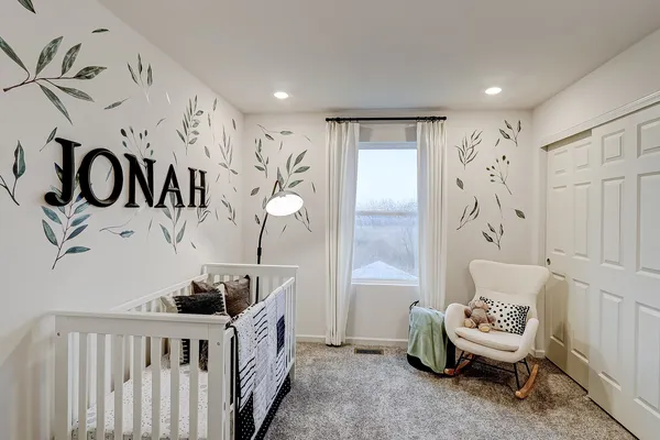 a bedroom with a bed and a mirror