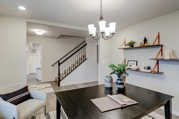 a view of a dining room with furniture wooden floor and a chandelier