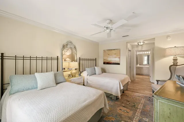 a spacious bedroom with two beds and a chandelier