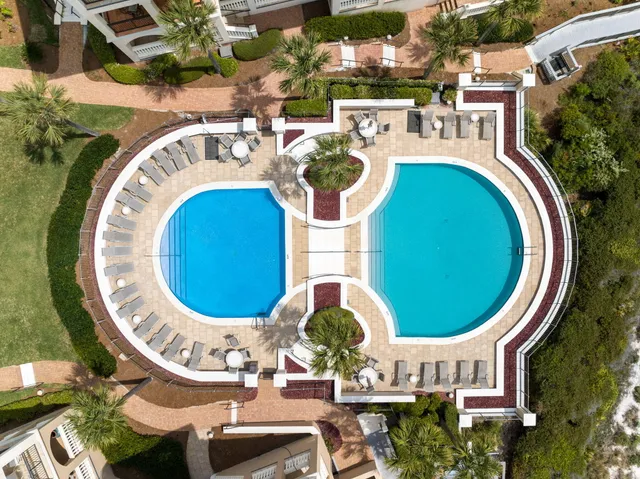 an aerial view of a house with swimming pool and outdoor space