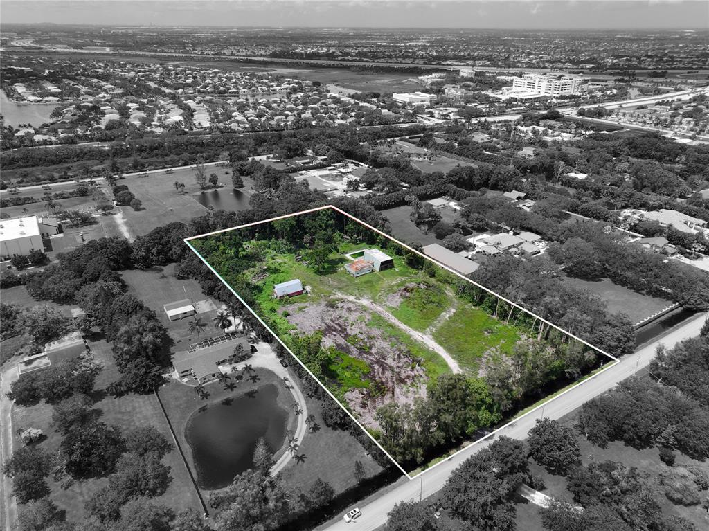 an aerial view of a residential houses with outdoor space and seating