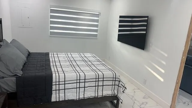a bedroom with a bed and a window