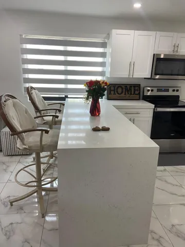a kitchen with a stove top oven and cabinets