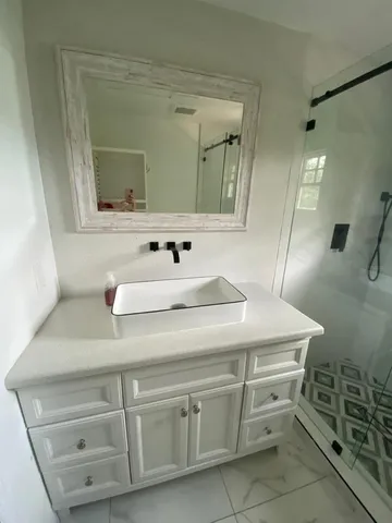 a bathroom with a sink and a mirror