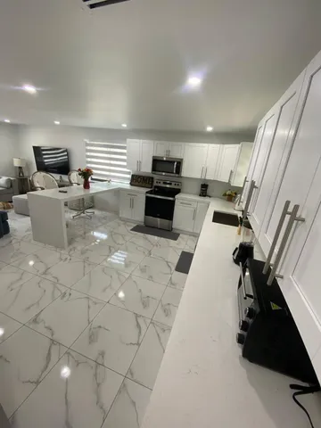 a kitchen with a sink stainless steel appliances and cabinets