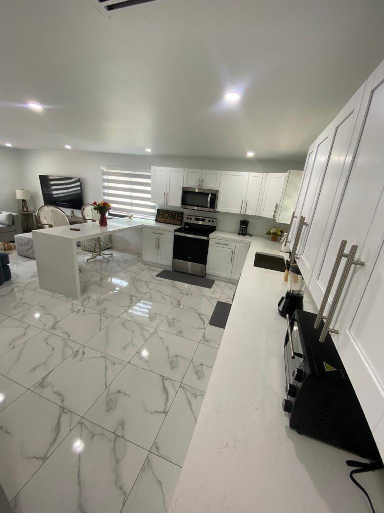 16355 Downers Drive East, Unit 2 Loxahatchee, FL 33470 - Photo 7 of 8 a kitchen with a sink stainless steel appliances and cabinets