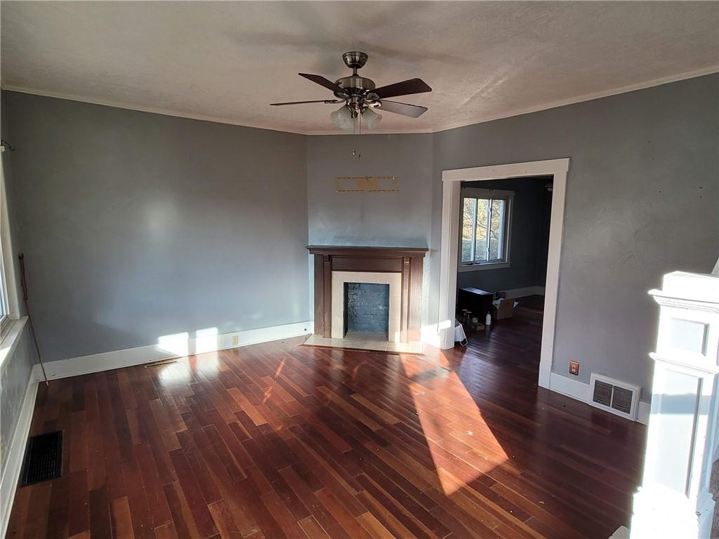 211 Summit Street Butler, PA 16001 - Photo 3 of 17 wooden floor in an empty room with a fireplace