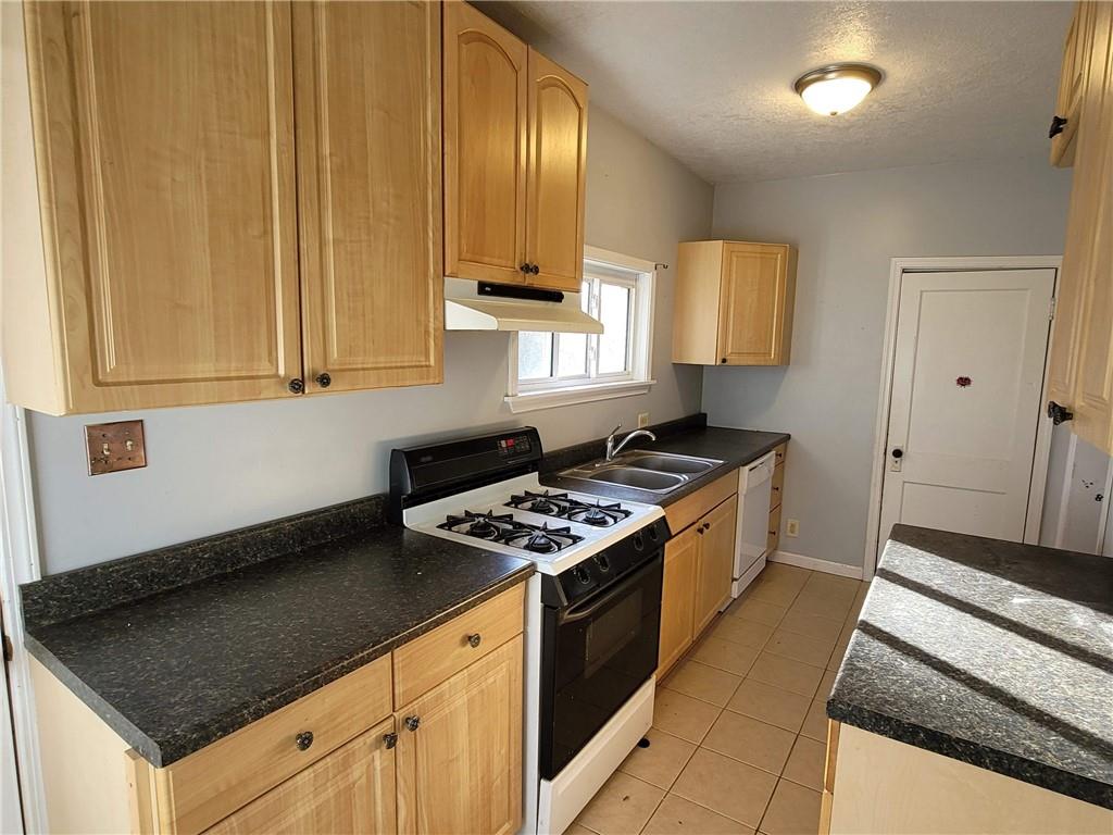 211 Summit Street Butler, PA 16001 - Photo 7 of 17 a kitchen with stainless steel appliances granite countertop a stove a sink and a microwave