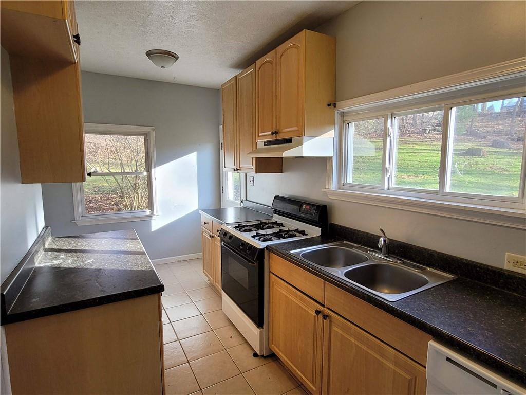 211 Summit Street Butler, PA 16001 - Photo 9 of 17 a kitchen that has a sink and a stove