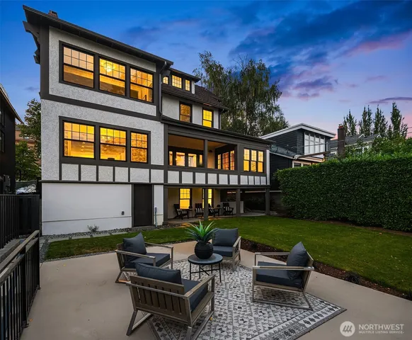 a view of a house with backyard and sitting area