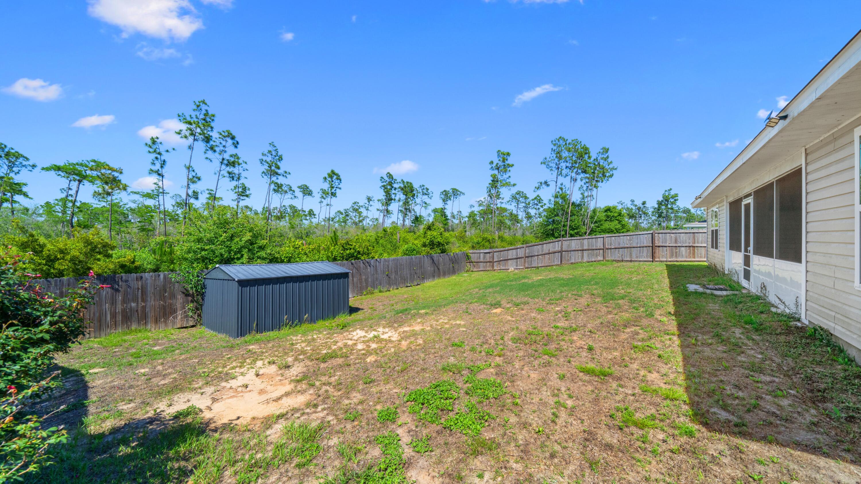 3927 Alva Thomas Road Panama City, FL 32404 - Photo 32 of 46 a view of a backyard with a garden