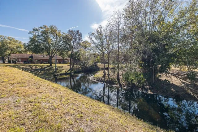 a view of a storage & utility room with window and wooden floor
