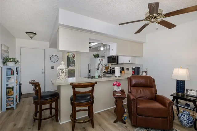 a kitchen with a refrigerator and a stove top oven