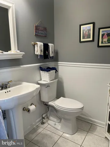 a bathroom with a granite countertop toilet and a sink