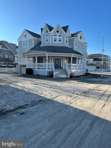 a view of a big house with a big yard and large trees