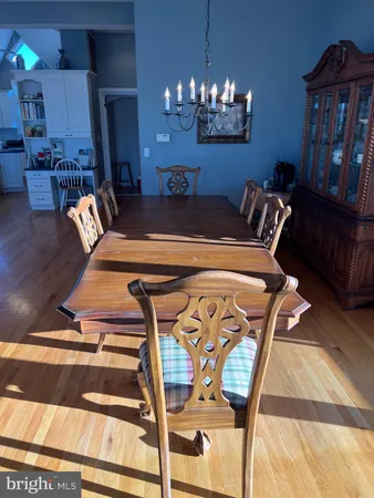 a view of a dining room with furniture and chandelier