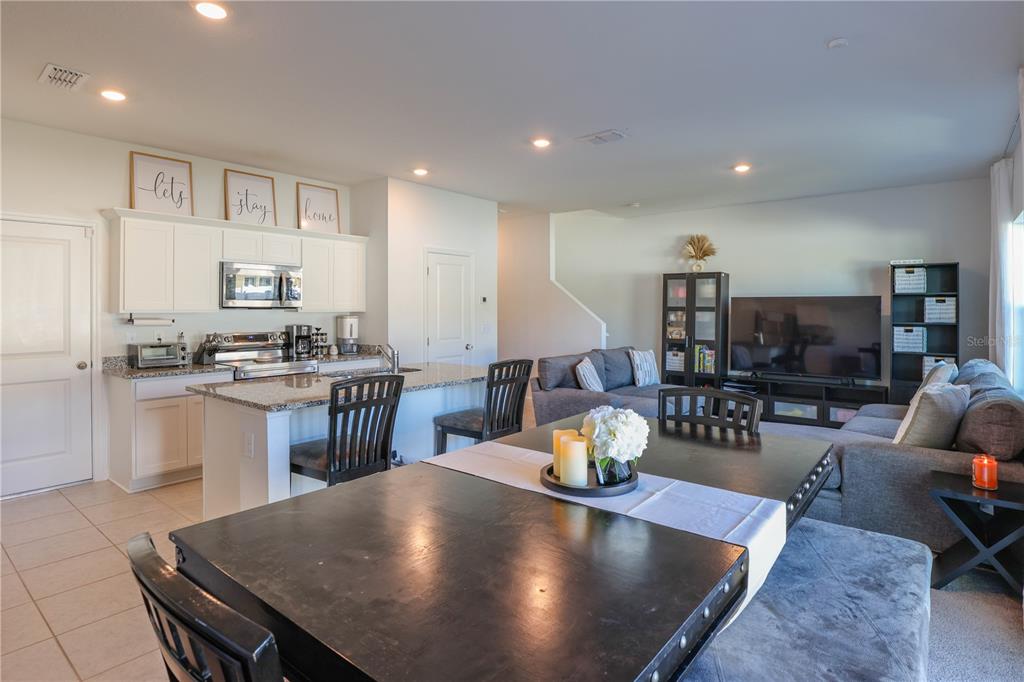 2240 Hemingway Circle Groveland, FL 34736 - Photo 15 of 34 a living room with stainless steel appliances furniture a rug and a kitchen view