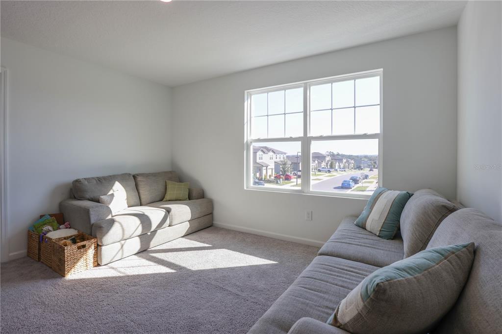 2240 Hemingway Circle Groveland, FL 34736 - Photo 18 of 34 a living room with furniture and a window