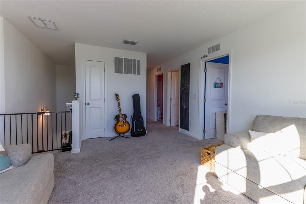 2240 Hemingway Circle Groveland, FL 34736 - Photo 19 of 34 a view of a bedroom with a furniture and wooden floor