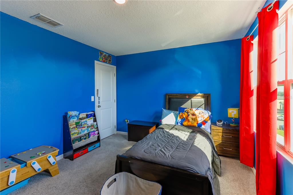 2240 Hemingway Circle Groveland, FL 34736 - Photo 21 of 34 a bedroom with a bed and a window