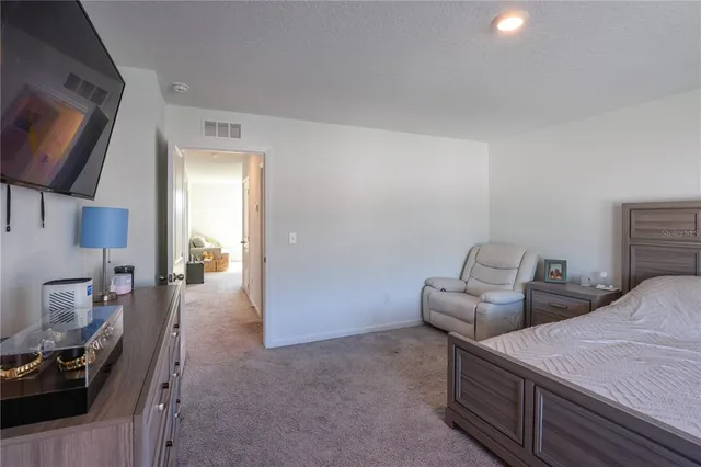 a bedroom with bed and a tv