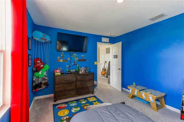 a living room with furniture and a baby crib