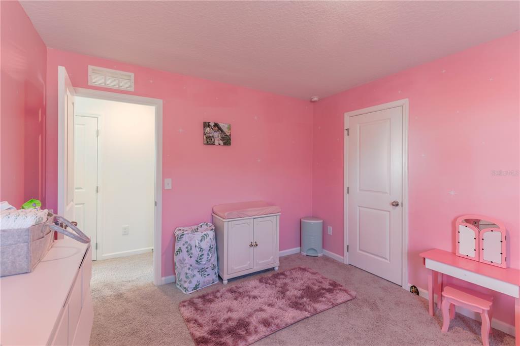 2240 Hemingway Circle Groveland, FL 34736 - Photo 25 of 34 a bedroom with a bed and a couch