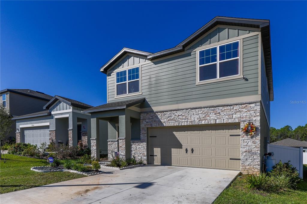 2240 Hemingway Circle Groveland, FL 34736 - Photo 3 of 34 a front view of a house with garden