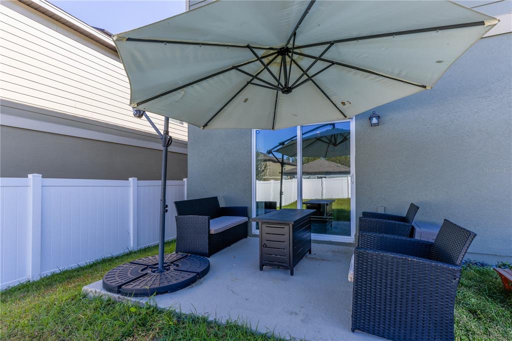 2240 Hemingway Circle Groveland, FL 34736 - Photo 32 of 34 a patio with a table and chairs