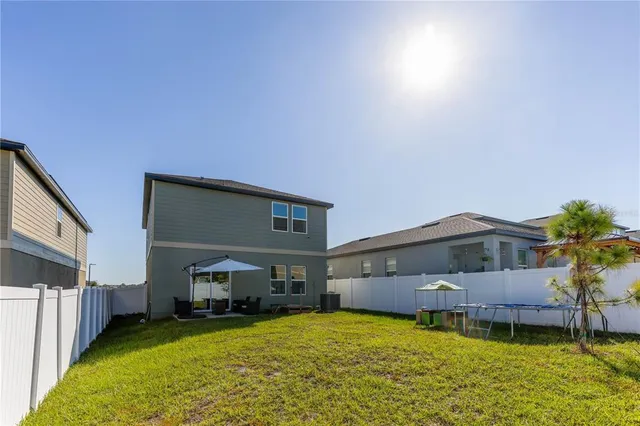 a view of a house with a yard and a garage