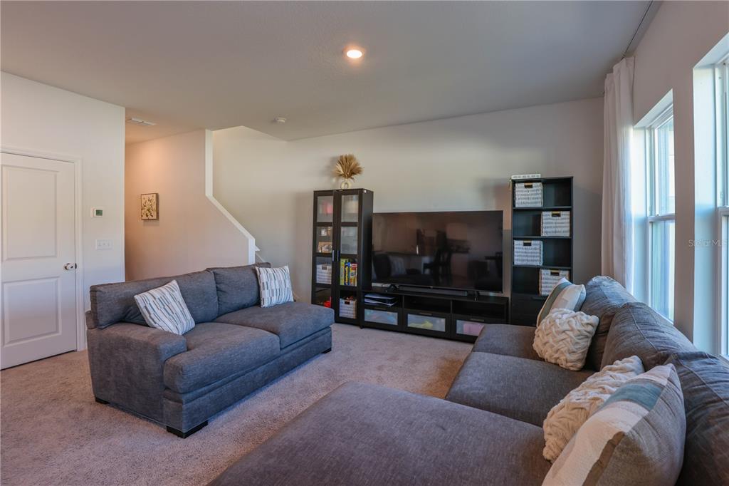 2240 Hemingway Circle Groveland, FL 34736 - Photo 9 of 34 a living room with furniture and a flat screen tv