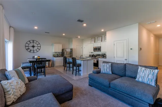a living room kitchen with furniture and kitchen view