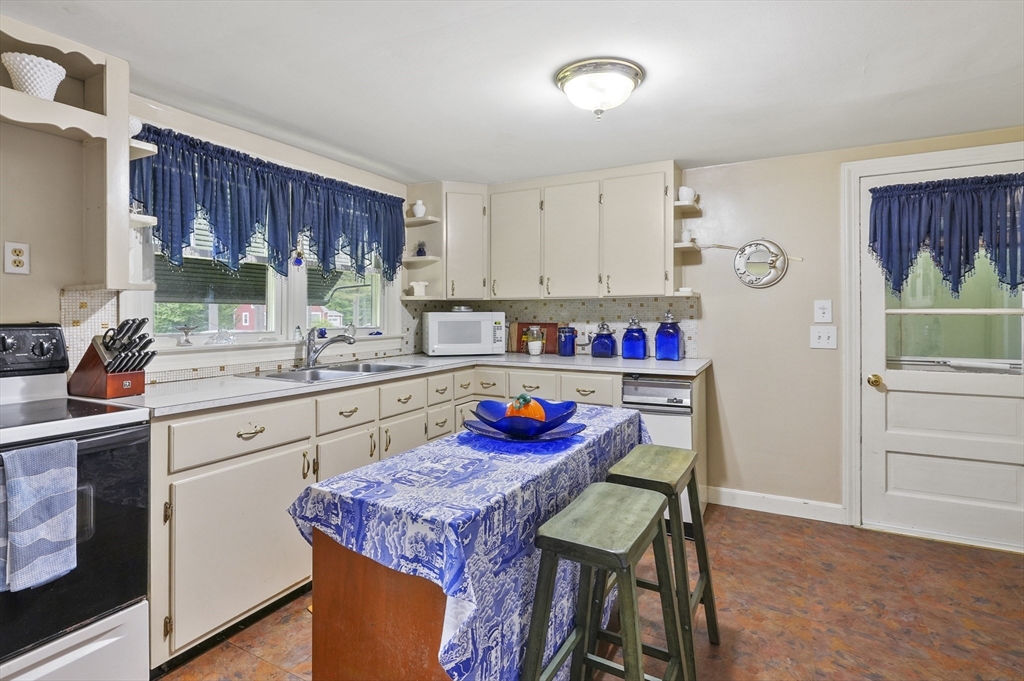 49 Winchendon Road Baldwinville, MA 01436 - Photo 13 of 33 a kitchen with stainless steel appliances granite countertop a sink a stove and a refrigerator
