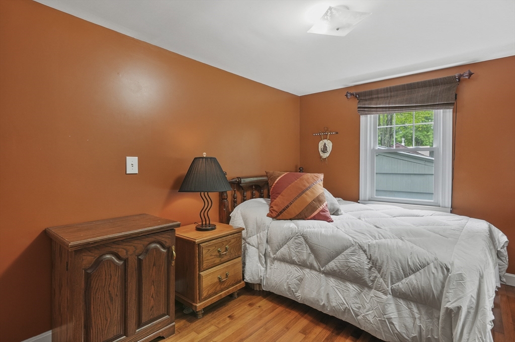49 Winchendon Road Baldwinville, MA 01436 - Photo 19 of 33 a bedroom with a bed and wooden floor