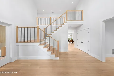 a view of staircase with white walls and a window