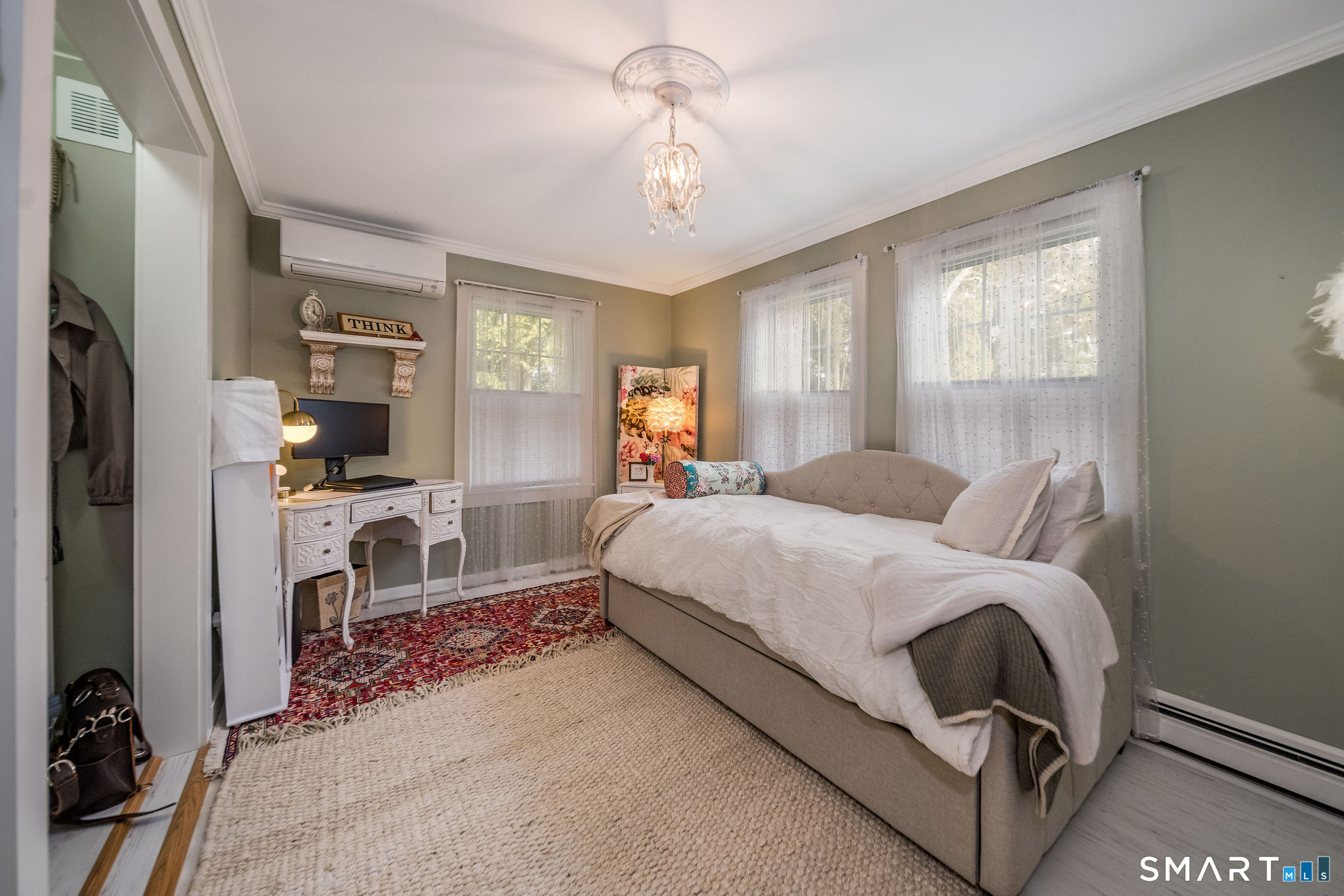 24 Cottage Place Old Saybrook, CT 06475 - Photo 14 of 38 a spacious bedroom with a bed and a chandelier