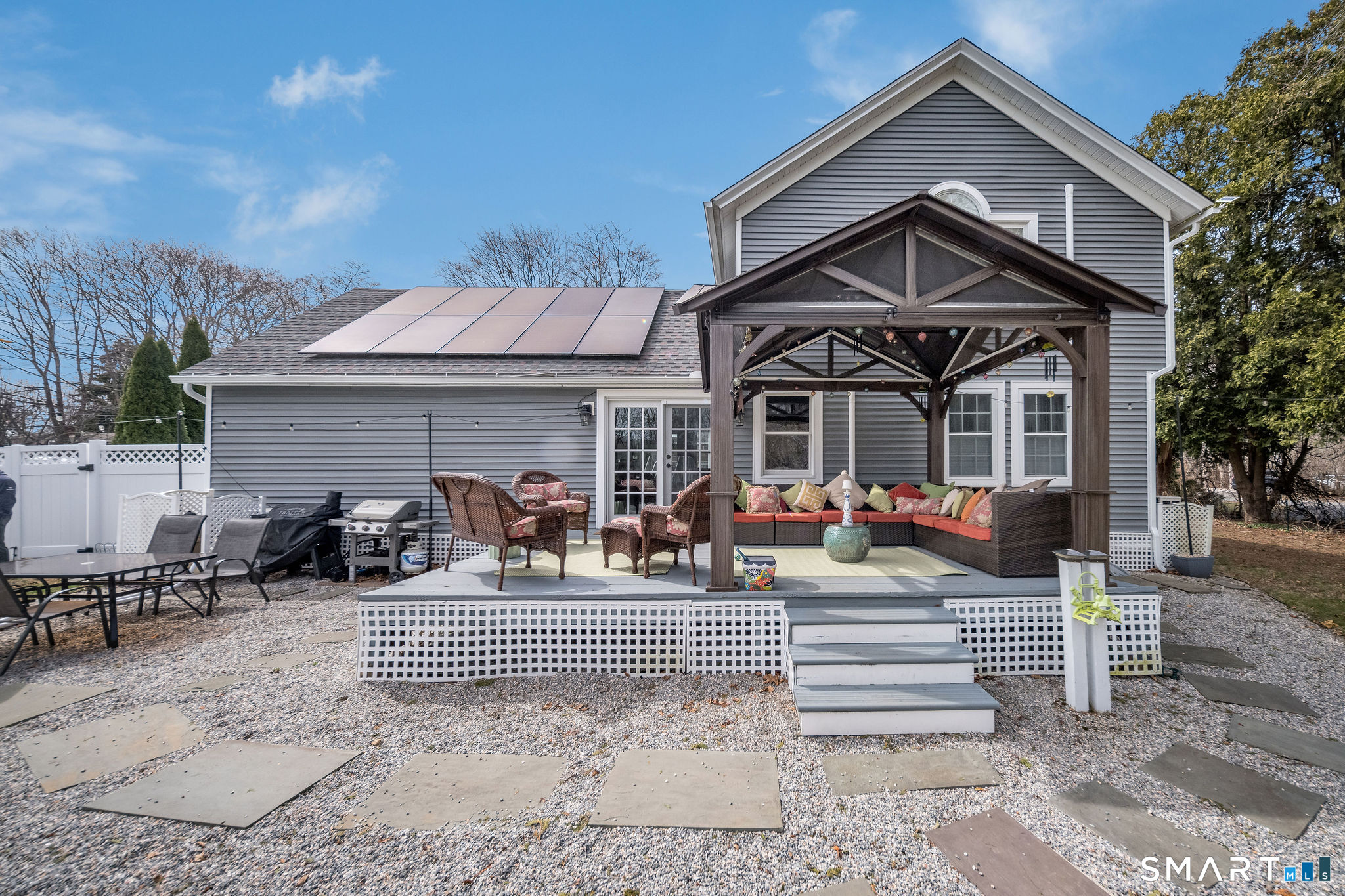 24 Cottage Place Old Saybrook, CT 06475 - Photo 26 of 38 a front view of a house with large windows and couches
