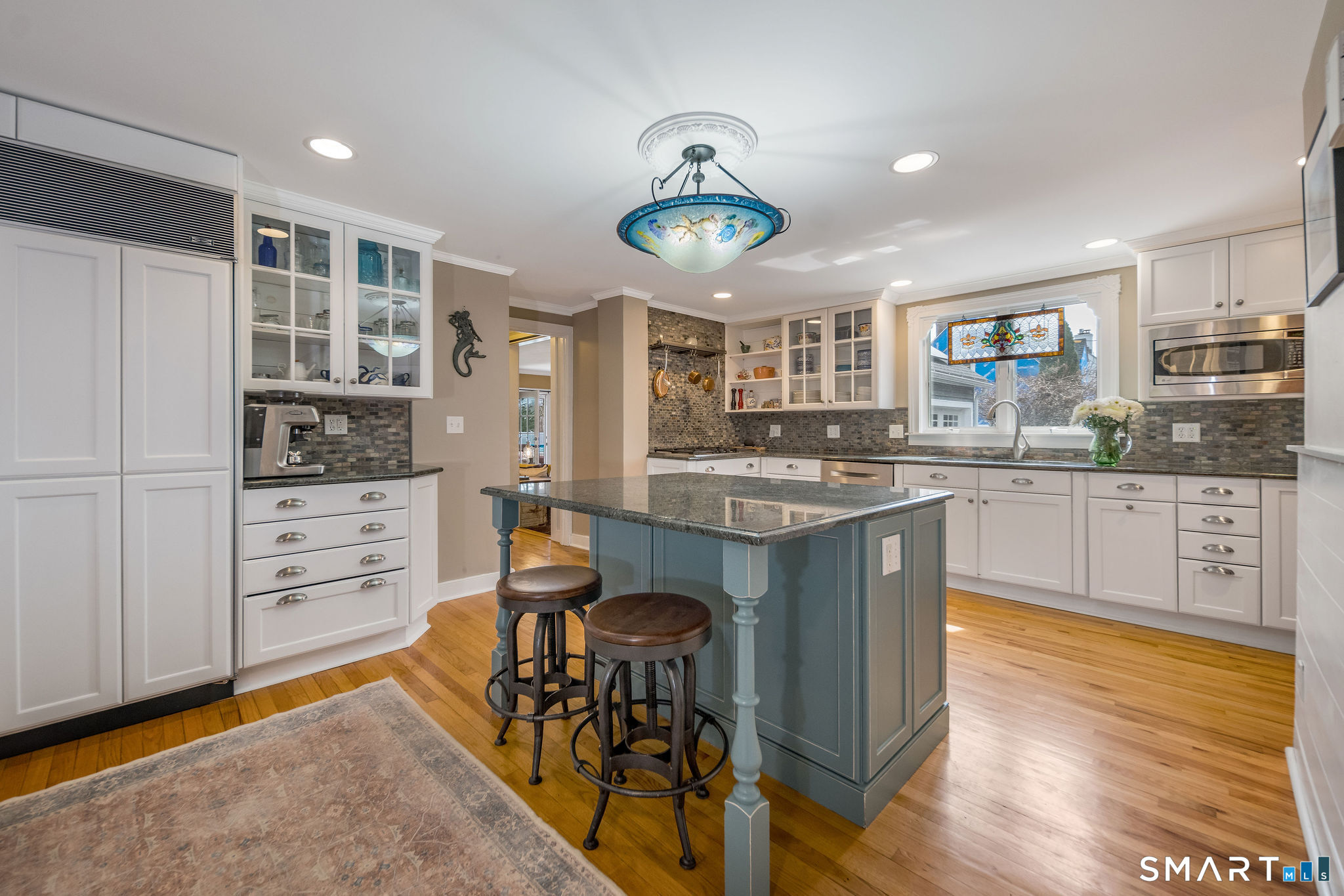24 Cottage Place Old Saybrook, CT 06475 - Photo 10 of 38 a kitchen with stainless steel appliances granite countertop a stove top oven a sink a dining table and chairs