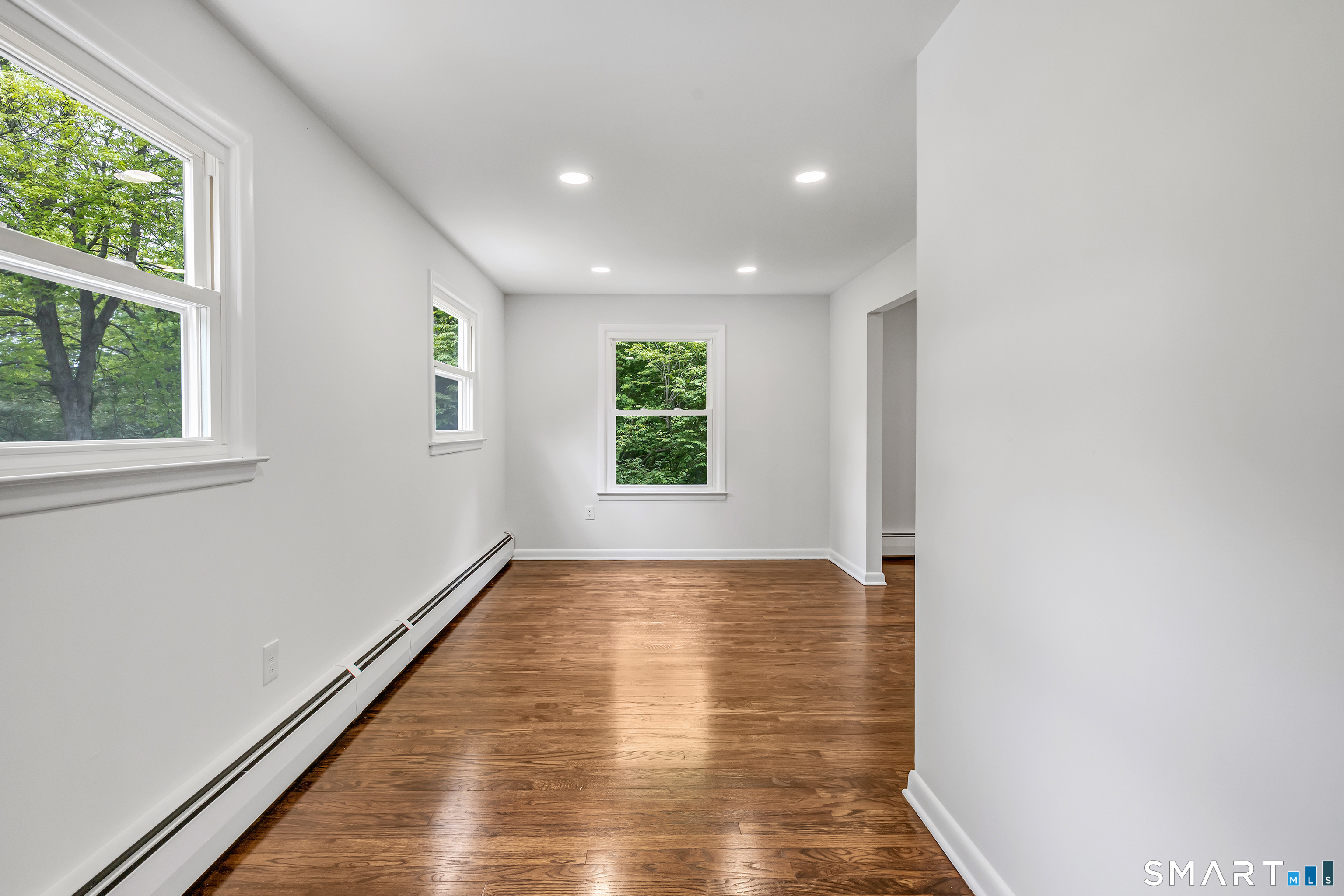 7 Longview Road Newtown, CT 06482 - Photo 15 of 40 a view of an empty room with wooden floor and a window