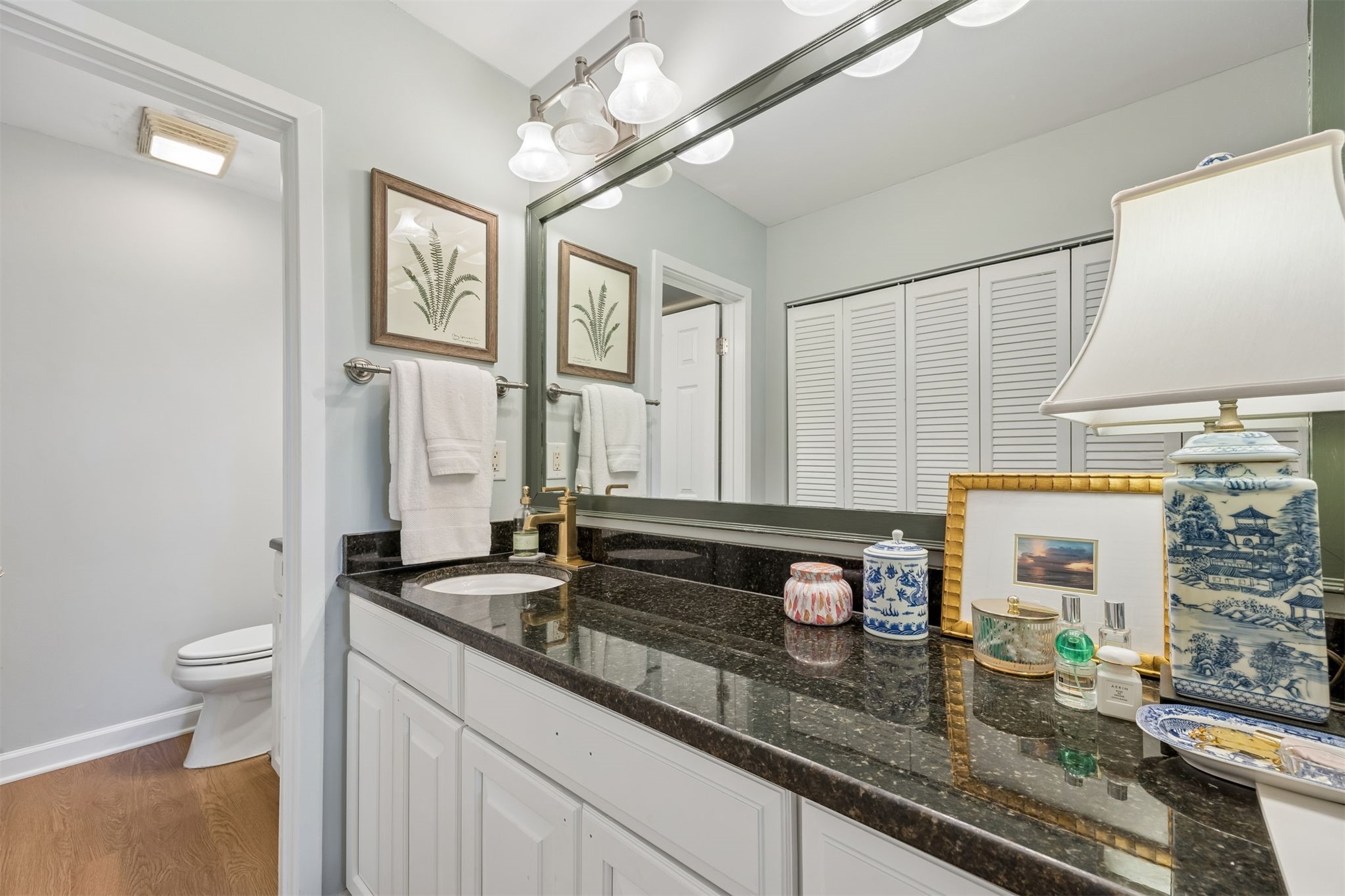 2005 Beachwood Road, Unit 2005 Amelia Island, FL 32034 - Photo 17 of 43 a bathroom with a granite countertop sink a toilet and a mirror