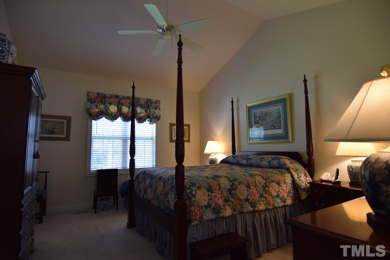 6404 Nowell Pointe Drive Raleigh, NC 27607 - Photo 12 of 24 a bedroom with a bed and a window