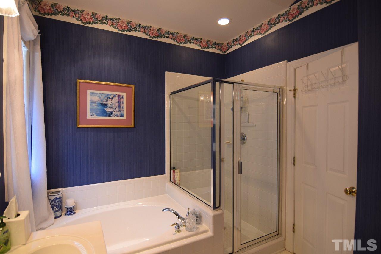 6404 Nowell Pointe Drive Raleigh, NC 27607 - Photo 15 of 24 a bathroom with a bathtub and a shower