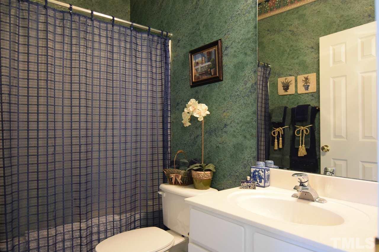 6404 Nowell Pointe Drive Raleigh, NC 27607 - Photo 16 of 24 a bathroom with a sink mirror toilet and shower