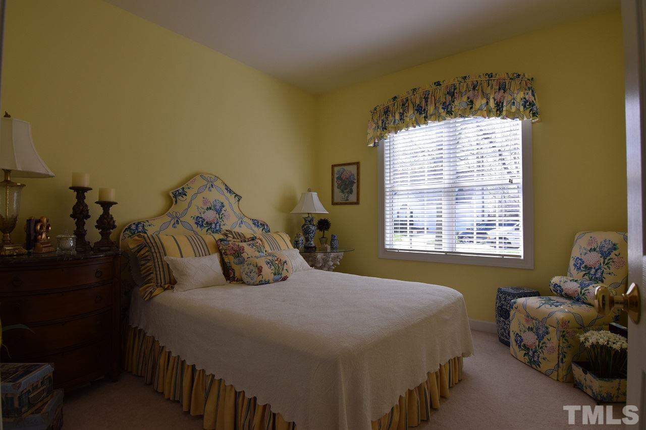 6404 Nowell Pointe Drive Raleigh, NC 27607 - Photo 17 of 24 a bedroom with a bed and a window