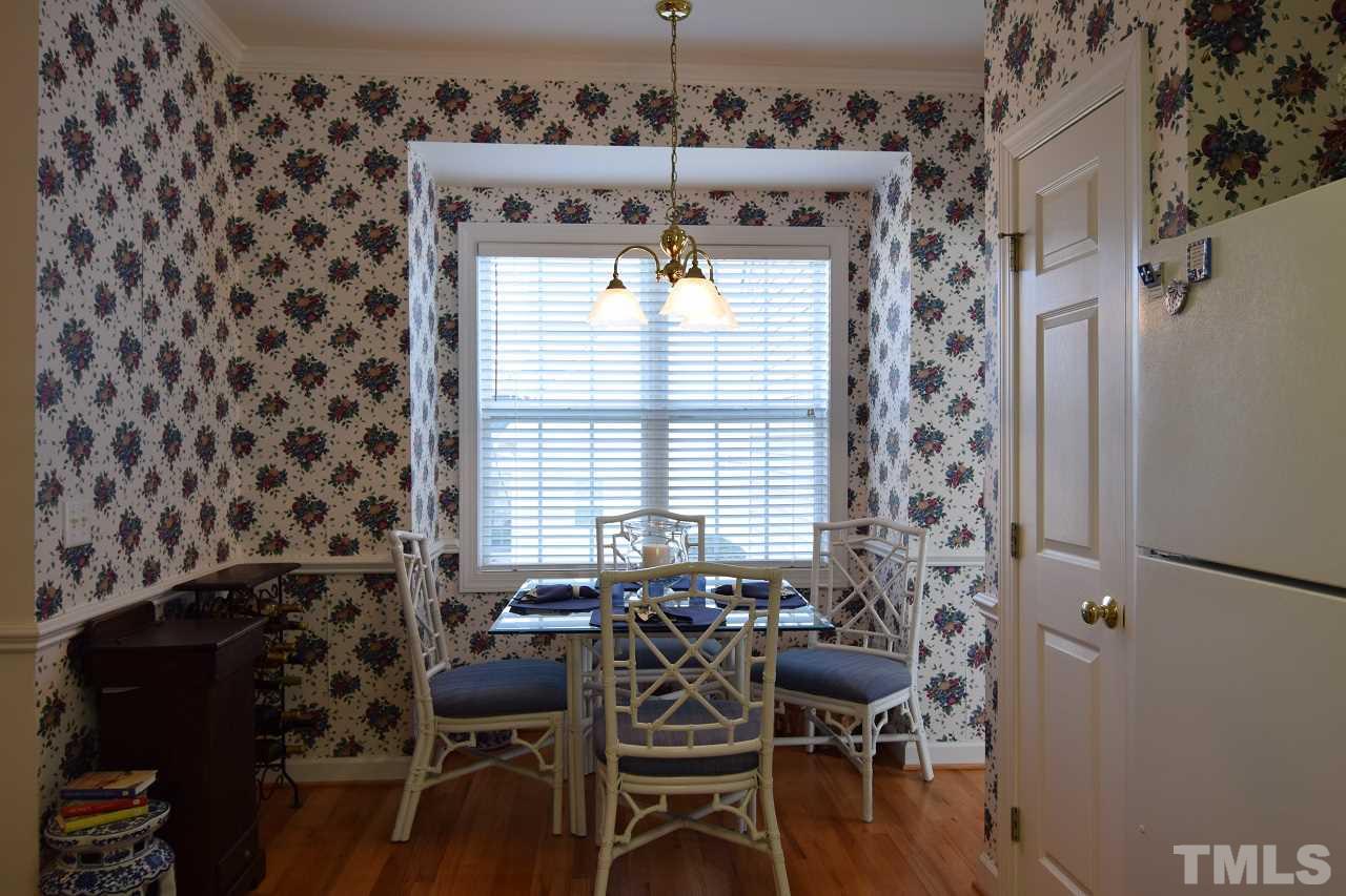 6404 Nowell Pointe Drive Raleigh, NC 27607 - Photo 7 of 24 a view of a dining room with furniture and wooden floor