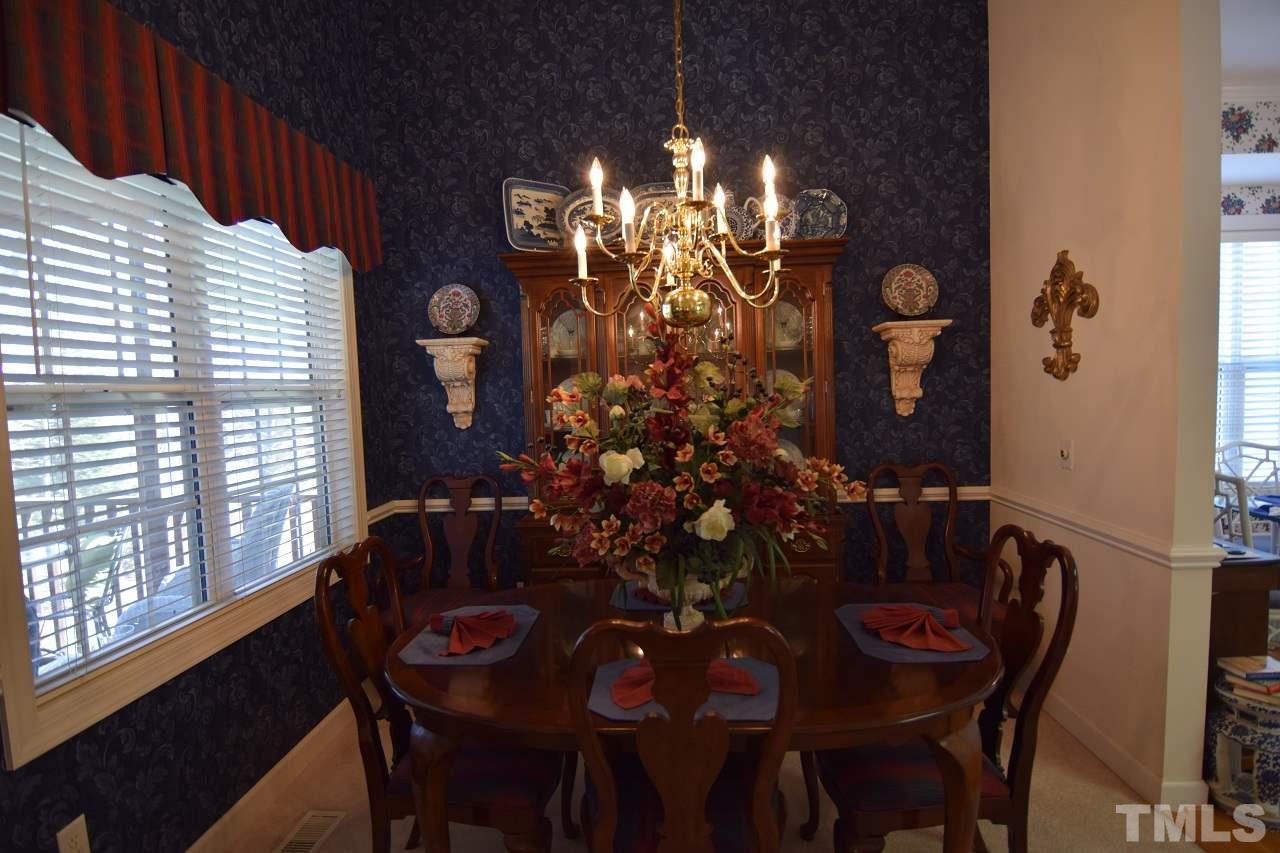 6404 Nowell Pointe Drive Raleigh, NC 27607 - Photo 8 of 24 a view of a dining room with furniture and chandelier
