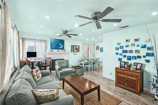 a living room with furniture kitchen view and a window