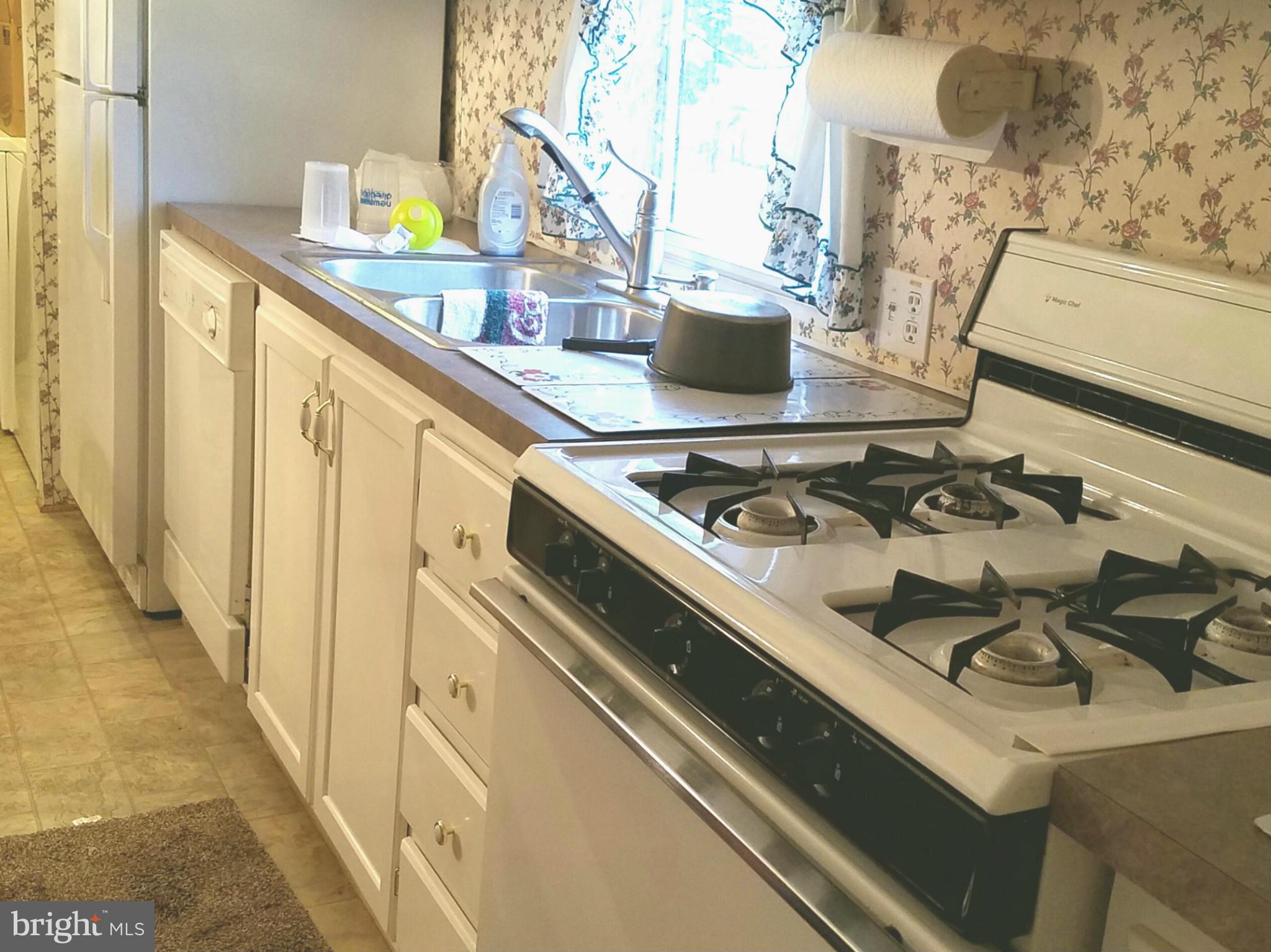 4630 Old Licksville Road Tuscarora, MD 21790 - Photo 4 of 9 a kitchen with a stove and a white refrigerator